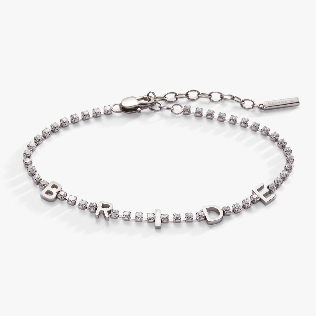 Silver tone tennis bracelet with the word BRIDE in crystal-studded letters against a white background