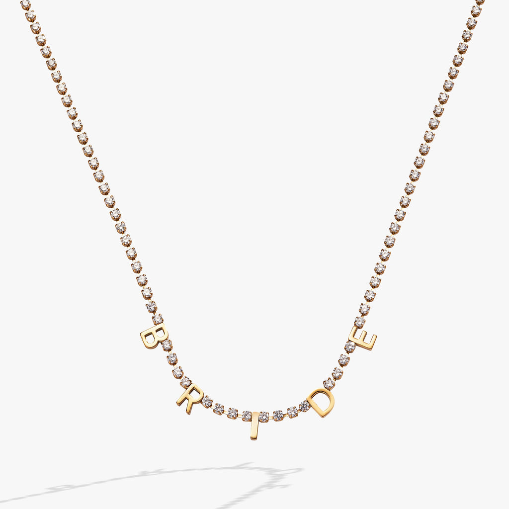 Close-up of the elegant Bride crystal tennis necklace on a bridal-themed background.