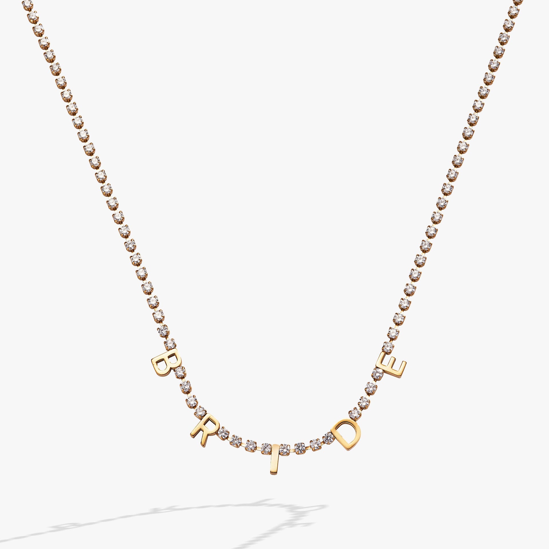 Close-up of the elegant Bride crystal tennis necklace on a bridal-themed background.