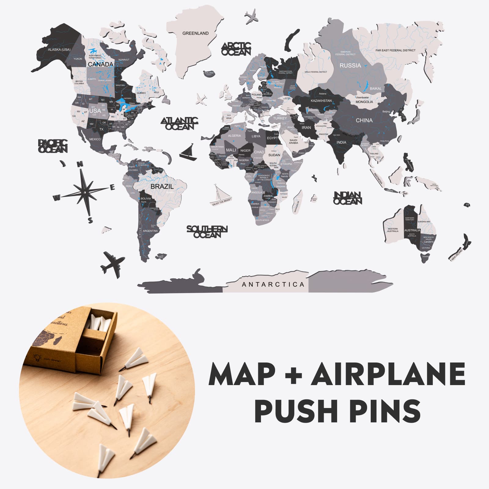 Minimalist wooden world map wall decor with airplane push pins in grey, white, and black