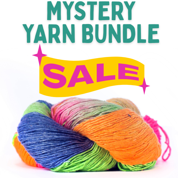 A beautiful collection of 6 lace-weight yarn hanks arranged in a box, showcasing various textures and shades.