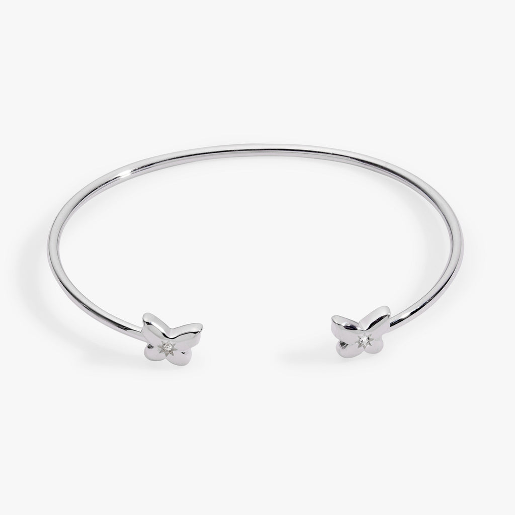 Silver-plated puffy butterfly cuff bracelet with clear crystal accents on a neutral background.