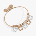Gold and silver tone butterfly charm bangle bracelet on a white background.
