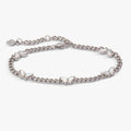 Silver curb chain bracelet with five crystal-accented butterfly charms.