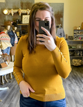 Mustard knit sweater with button detailing on the shoulder and sleeve