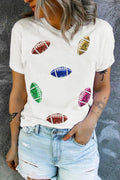 A woman wearing a white short sleeve t-shirt featuring multi-colored sequin football patches.