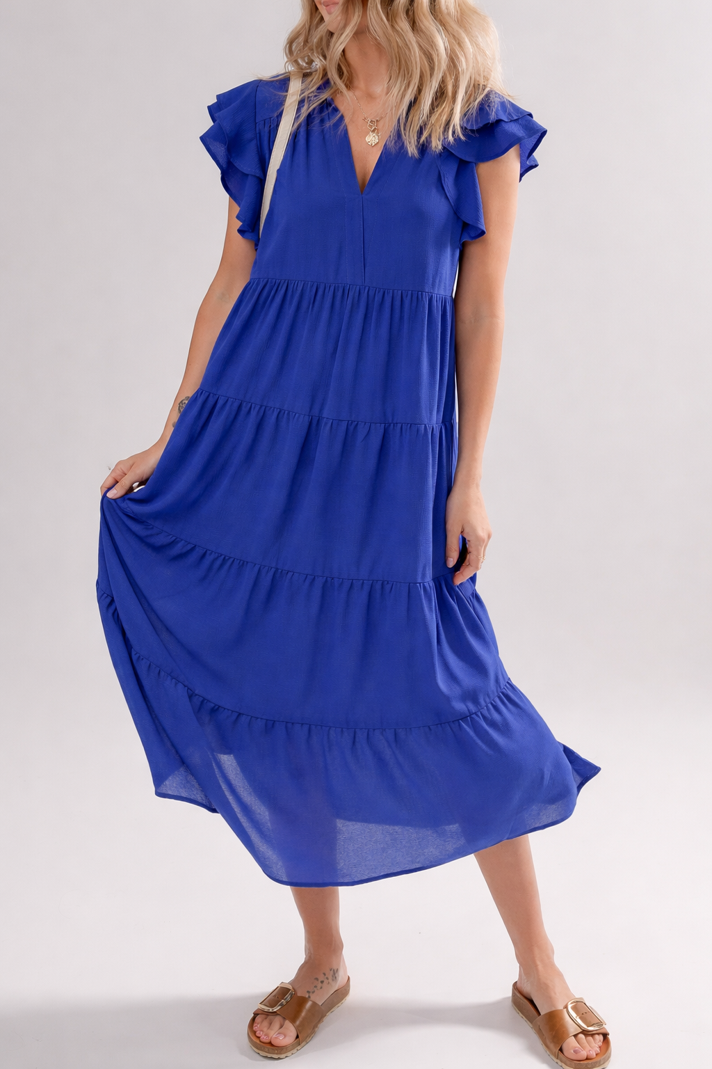 Solid color tiered midi dress with collar and ruffle sleeve details