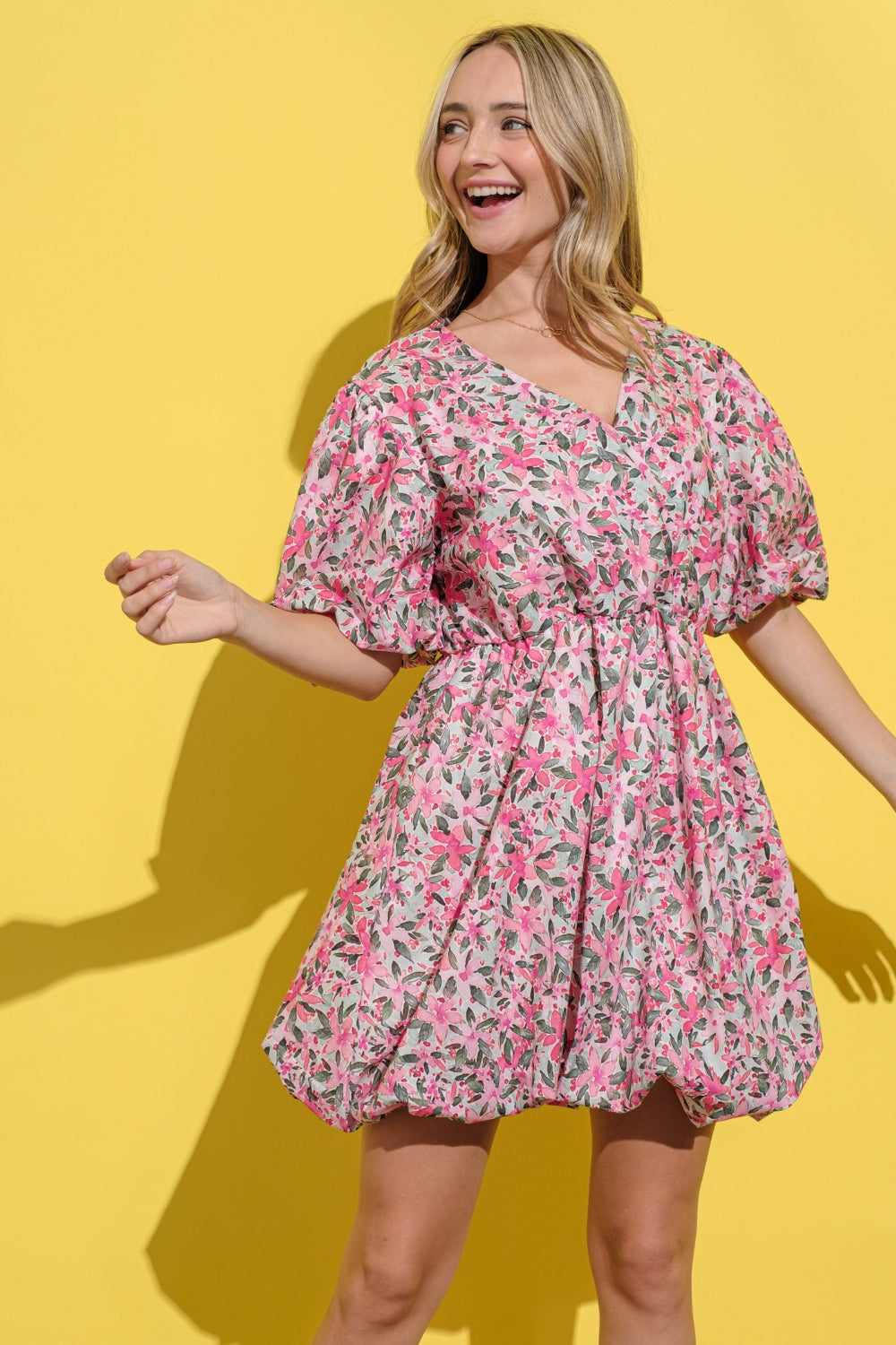 Floral print dress with surplice neckline and puff sleeves in pink, green, and white