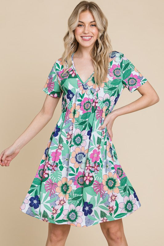 Floral print V-neck dress with ruched waist and short sleeves in green, white, and pink.