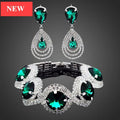 Glamorous bridal jewelry set featuring pear-cut blue crystals and cubic zirconia drop earrings