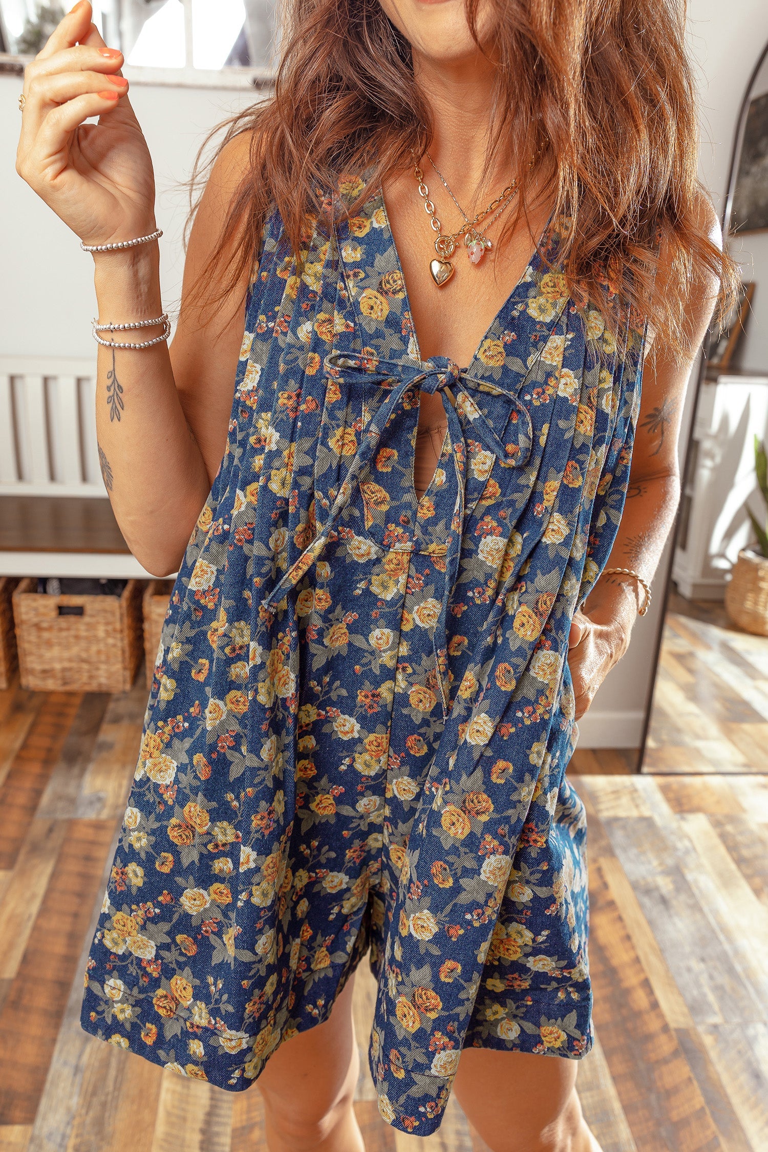 Blue retro floral print sleeveless denim romper with V-neck and bow tie detail