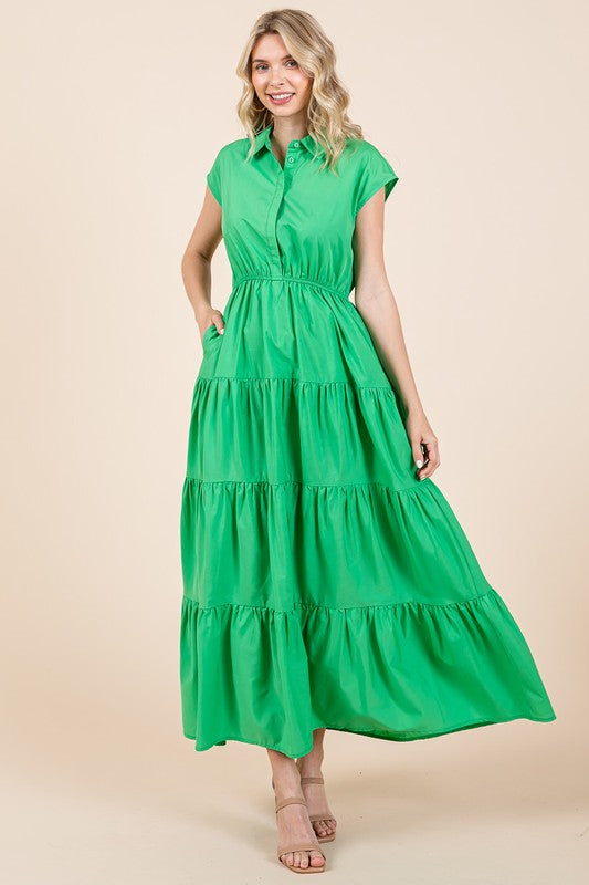 Woman wearing a button-up collared tiered maxi shirt dress with a flowing silhouette