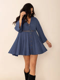 Dusty blue long sleeve mini dress featuring button accents and a stylish cutout detail.