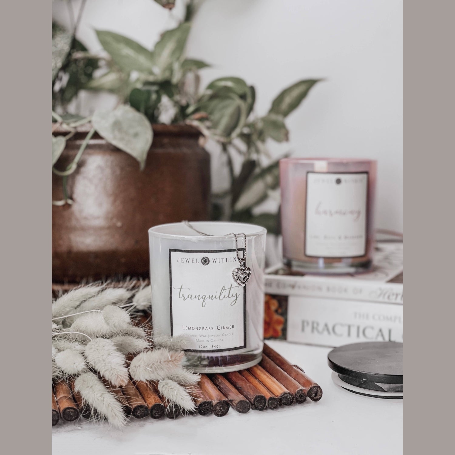 Tranquility candle in a black glass jar with hidden 925 Sterling silver jewelry inside
