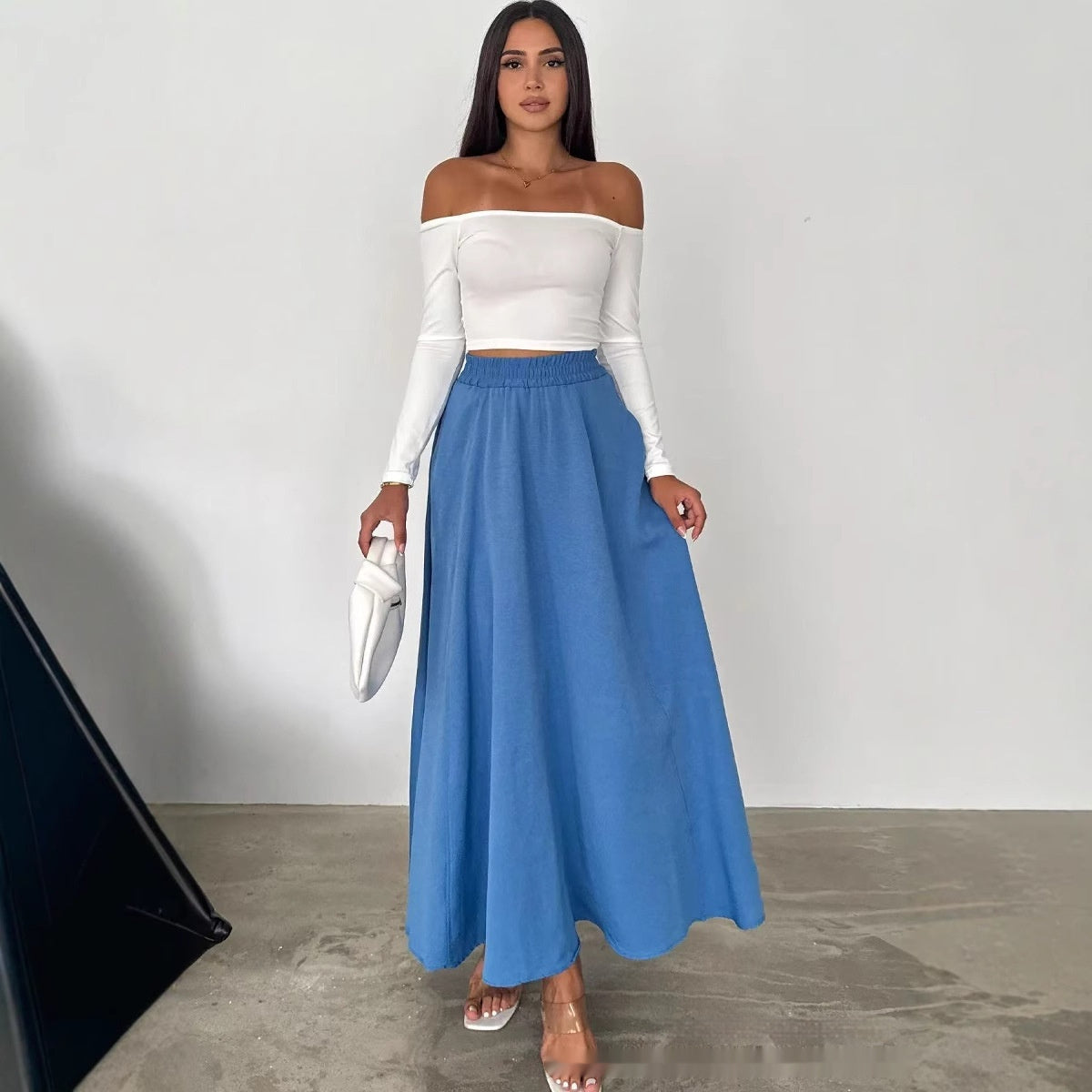 A woman wearing a loose A-line long dress in solid color, available in Rose Red, Blue, and Khaki.