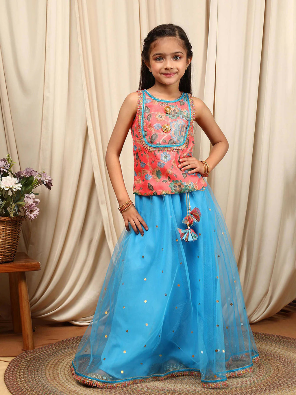 Little girl wearing a multi-color net lehenga choli set for festive occasions