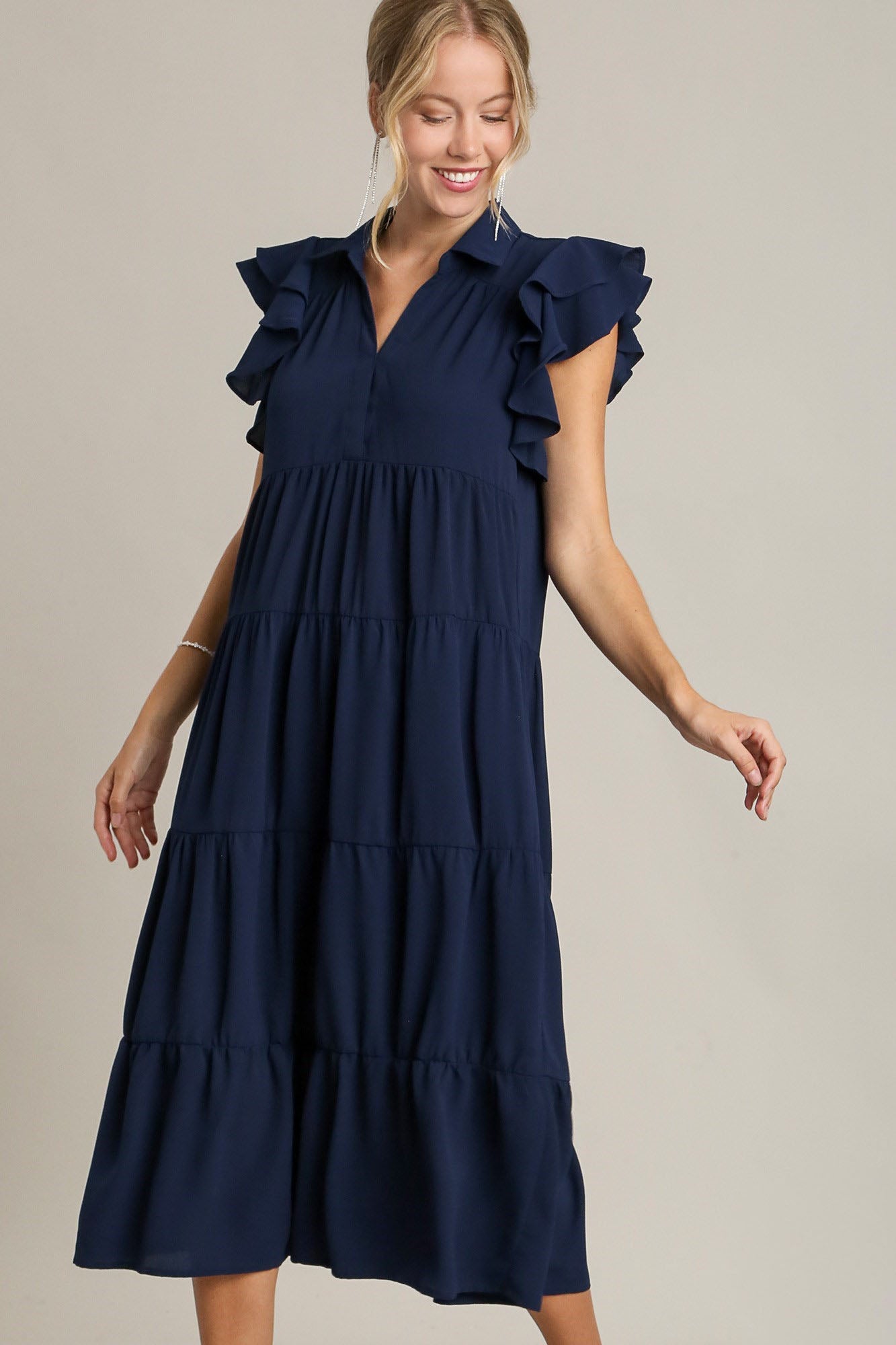 Dark navy tiered dress with ruffle cap sleeves and a classic collar.