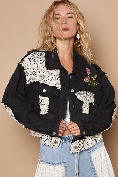 Black cotton jacket featuring colorful crochet patches and detailed embroidery on the sleeves/front.