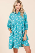 Model wearing a zebra print button-down shirt mini dress with tiered detailing.