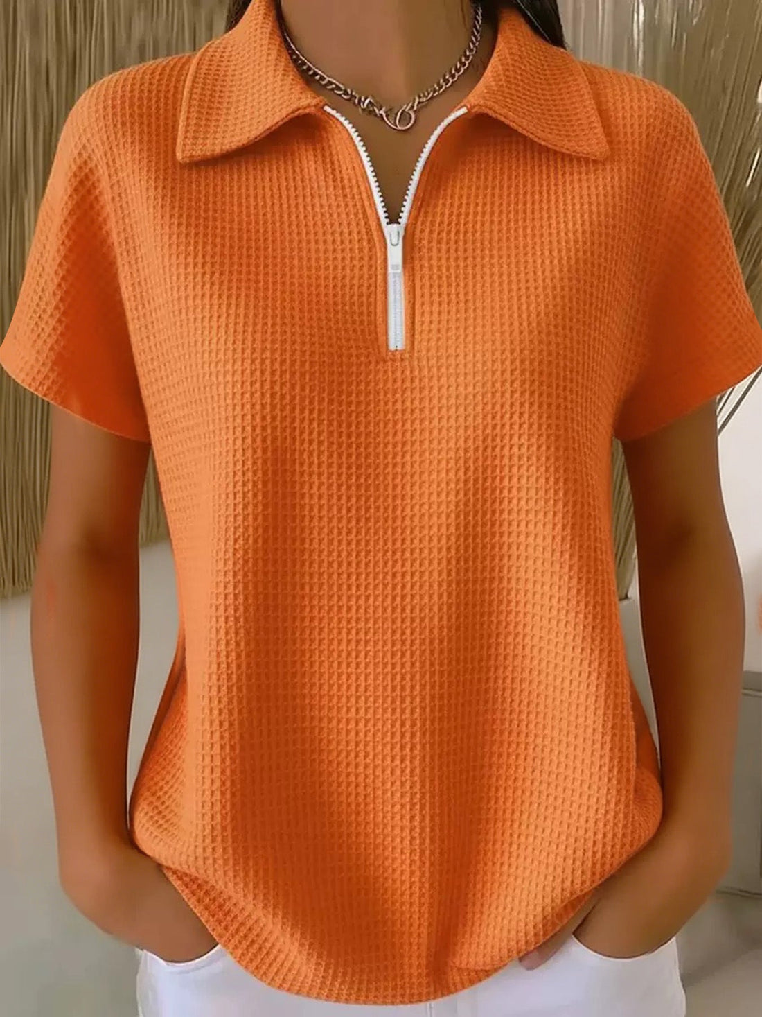 Women wearing a minimalist drop shoulder half-zip waffle knit pullover in solid color