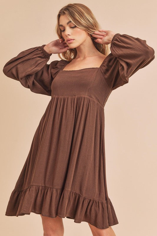 Trendy mini dress with a square neckline, long balloon sleeves, and a ruffled hem