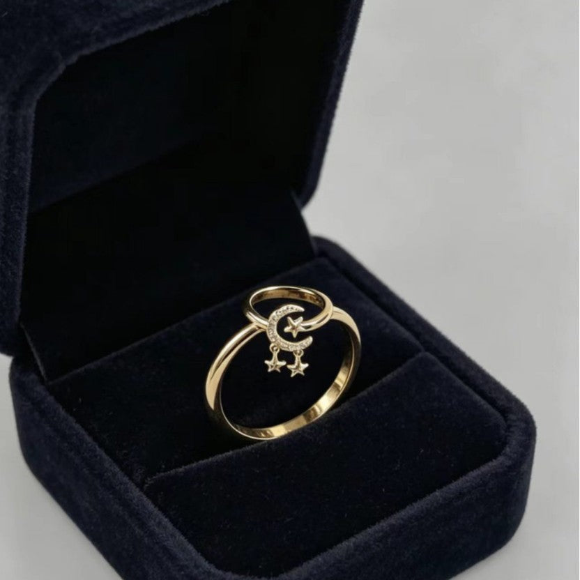 Elegant gold-tone adjustable open ring featuring star and moon charms.