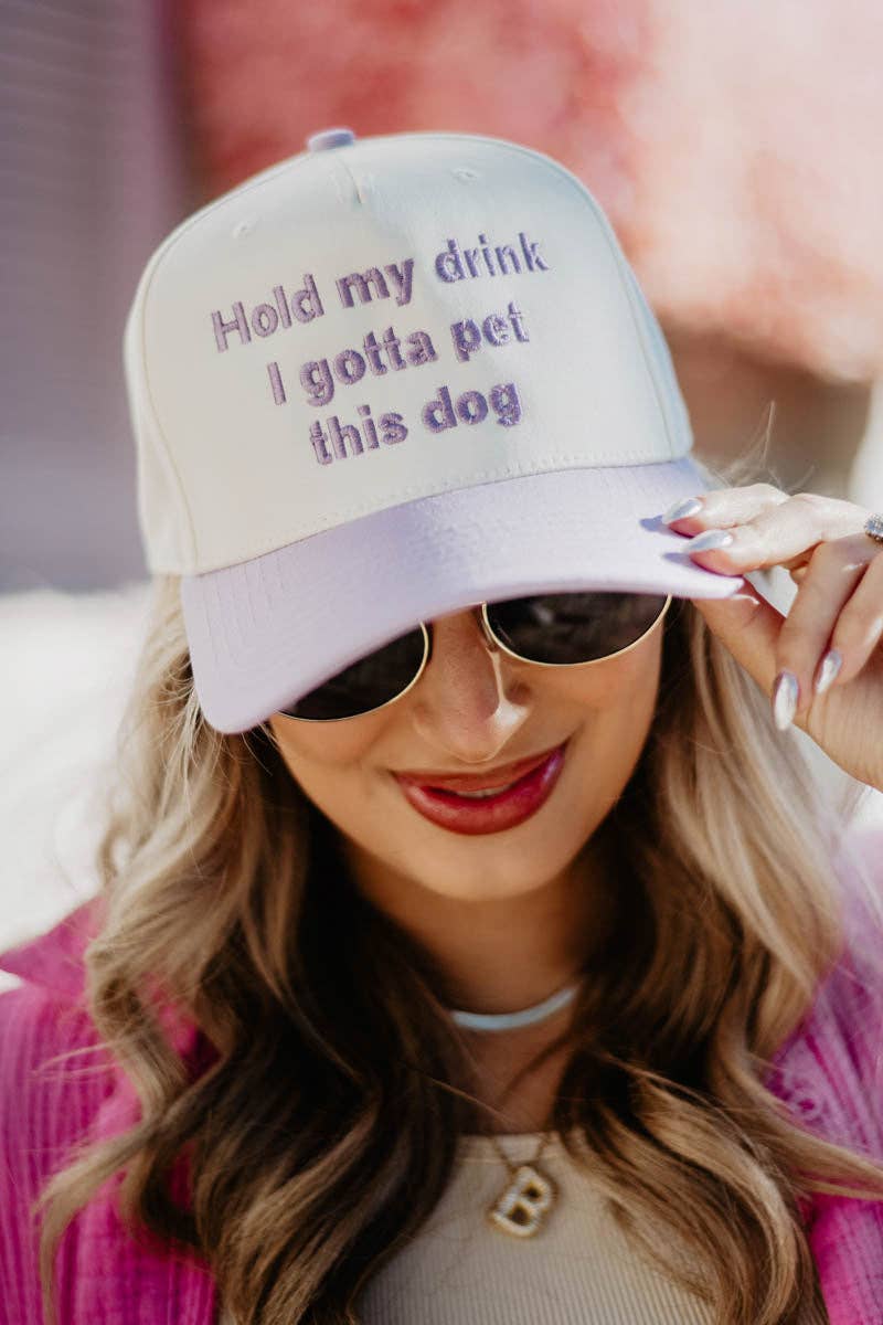 Person wearing a cap with text and sunglasses, blurred background