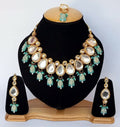 Elegant Firozi color Kundan necklace set with gold plating.