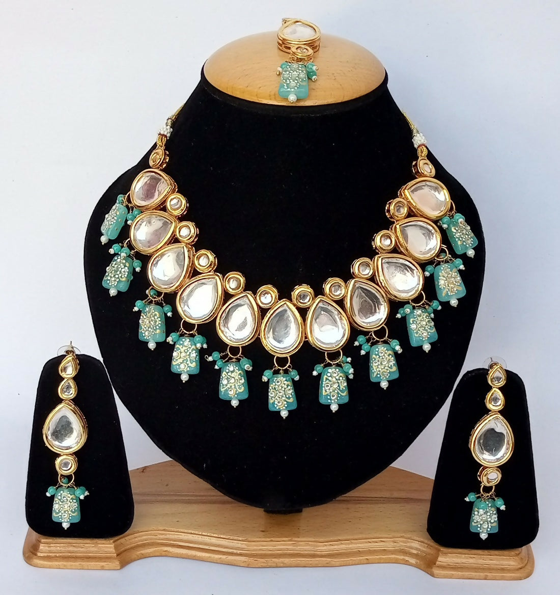 Elegant Firozi color Kundan necklace set with gold plating.