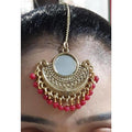 Gold-plated Chandbali maang tikka with mirror work and hanging red pearls for ethnic attire