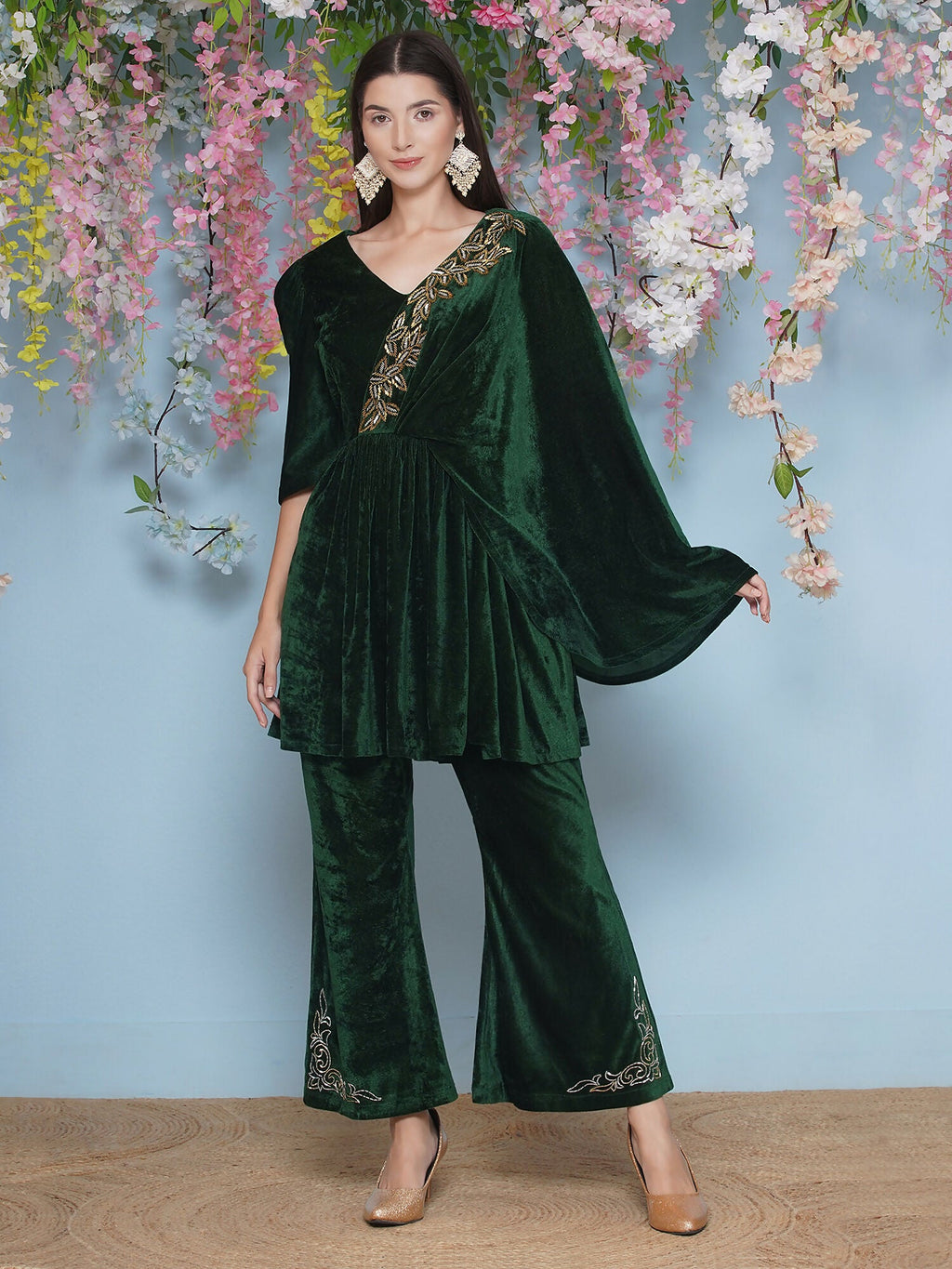 A luxurious green velvet two-piece set featuring intricate hand embellishments.