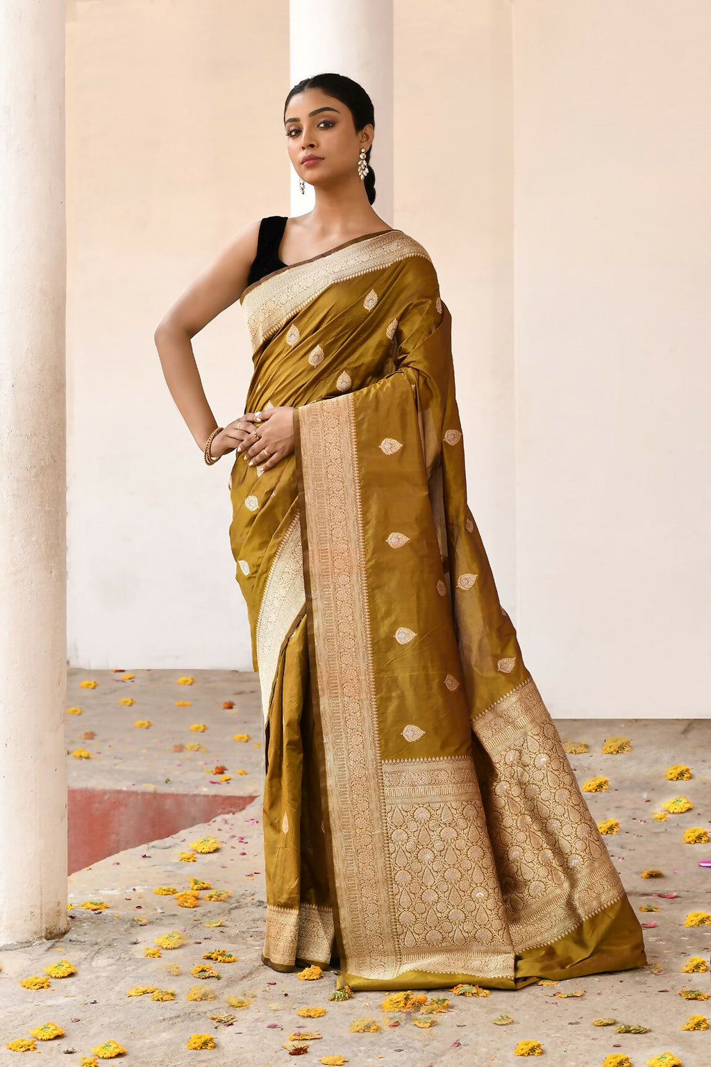Olive colored pure Katan handloom Banarasi silk saree with high-quality weaving.