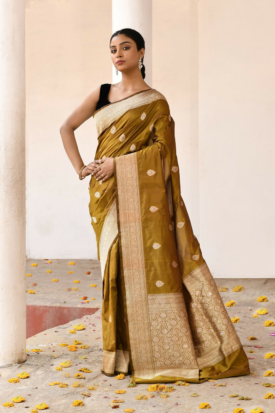 Olive colored pure Katan handloom Banarasi silk saree with high-quality weaving.