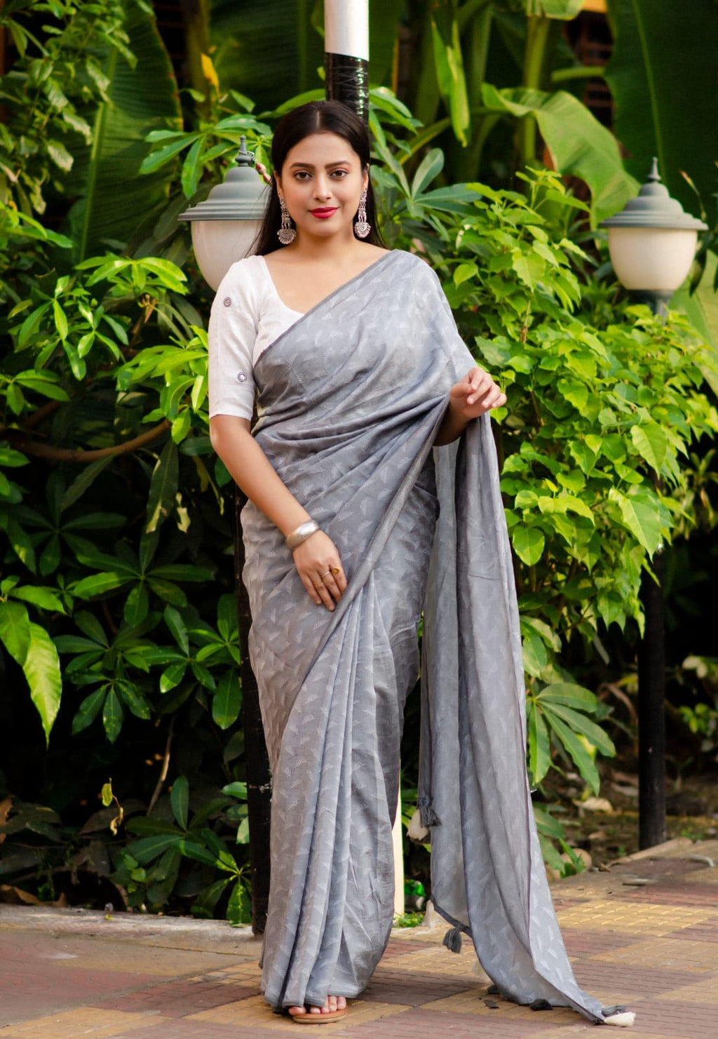 Grey poly georgette saree with woven white leaf pattern and mirror work blouse