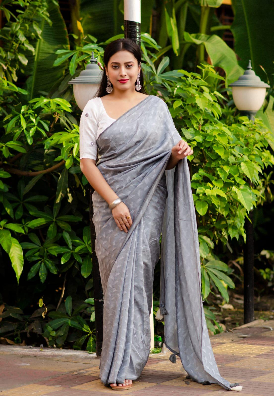 Grey poly georgette saree with woven white leaf pattern and mirror work blouse