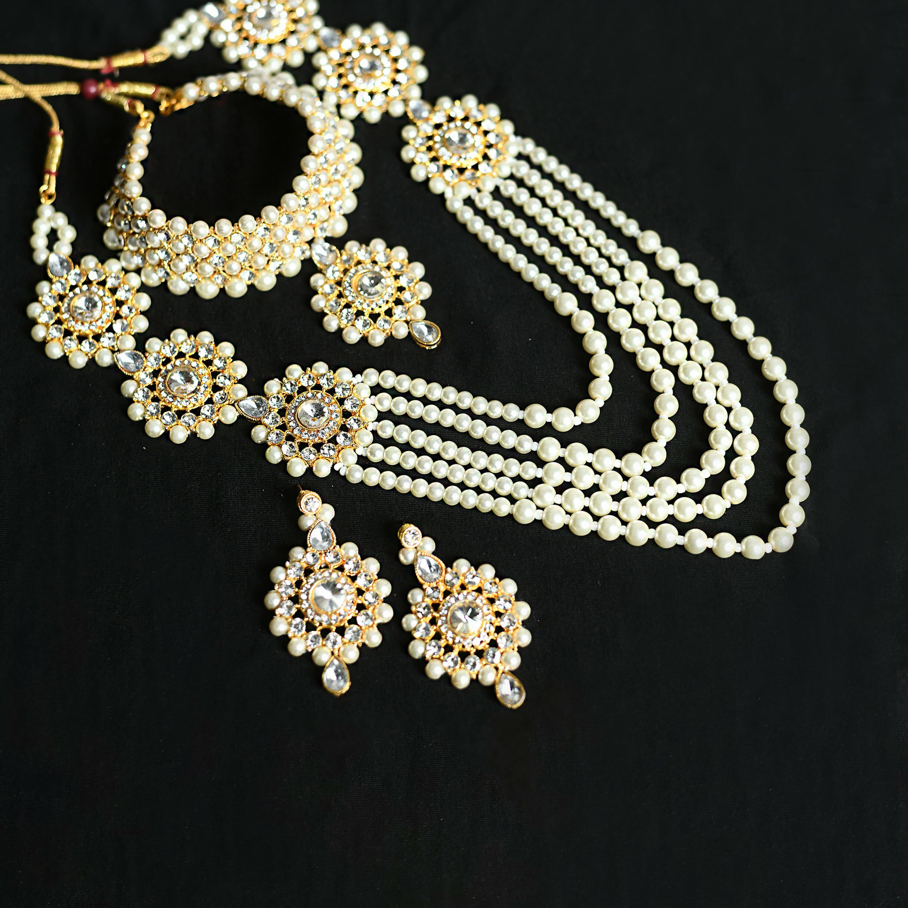 Long gold-polished Rani Haar necklace set with off-white pearls and Kundan stones