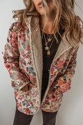 Woman wearing a vintage bohemian style floral print hooded jacket in vibrant autumn colors.