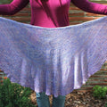 Close up of a periwinkle and lavender scalloped knit shawl.