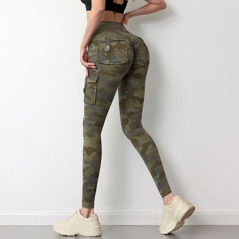 Woman wearing camouflage yoga leggings with side pockets and elastic waistband for fitness training.