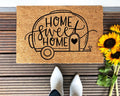 Tan and black campers doormat made of natural coir at a front entryway