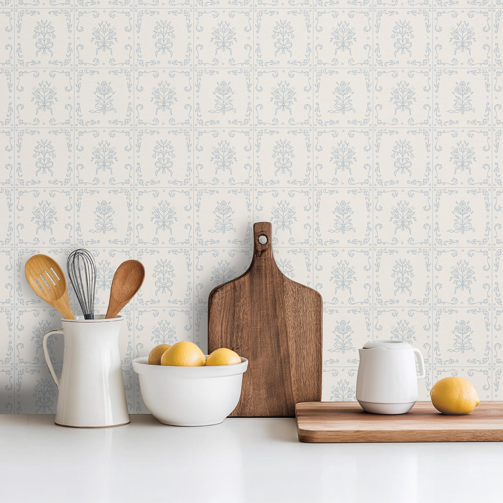 Wrenna floral wallpaper with dusty-rose and pale-blue flowers on an off-white background