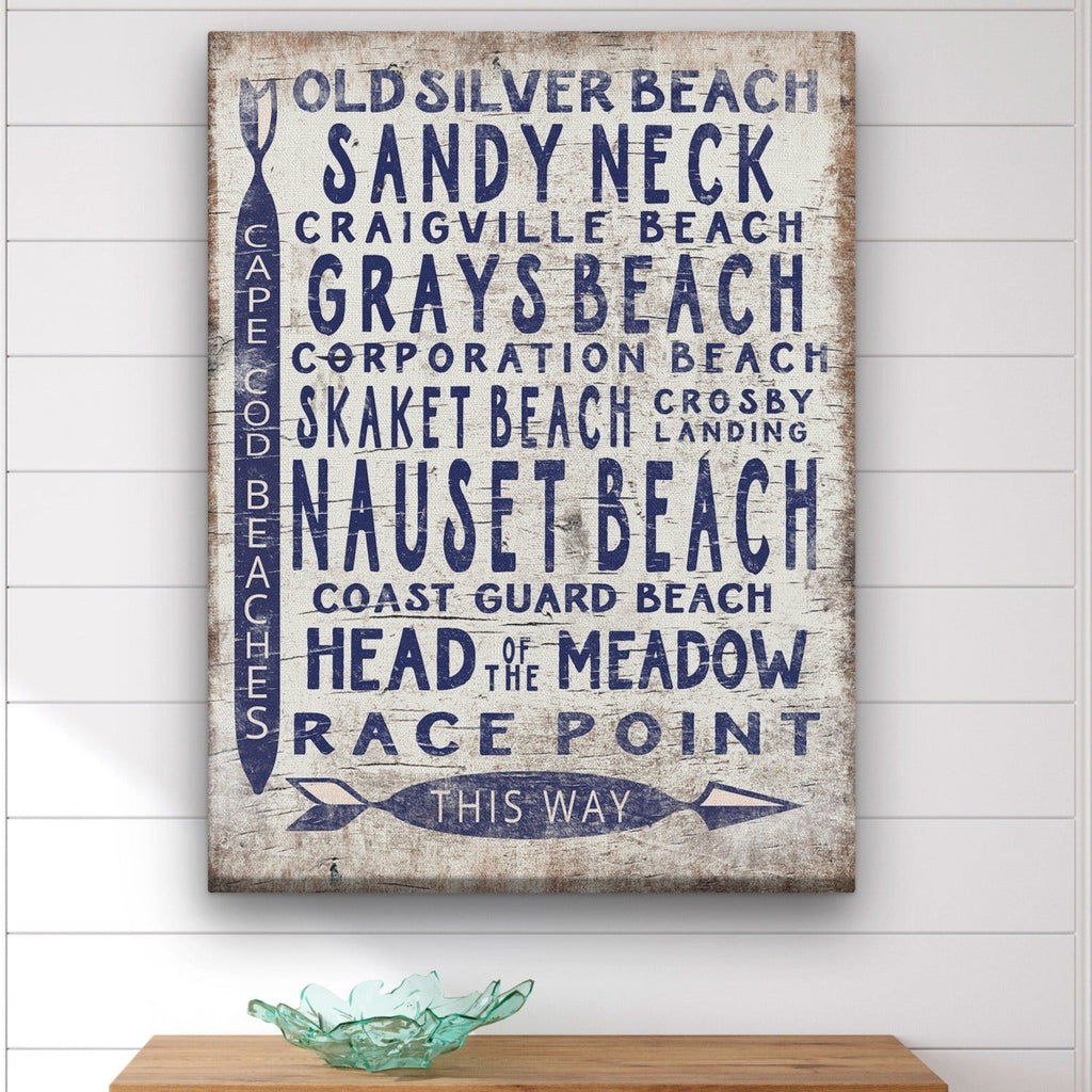 Vintage coastal Cape Cod beach sign on white-washed wood with navy blue text featuring various beach names