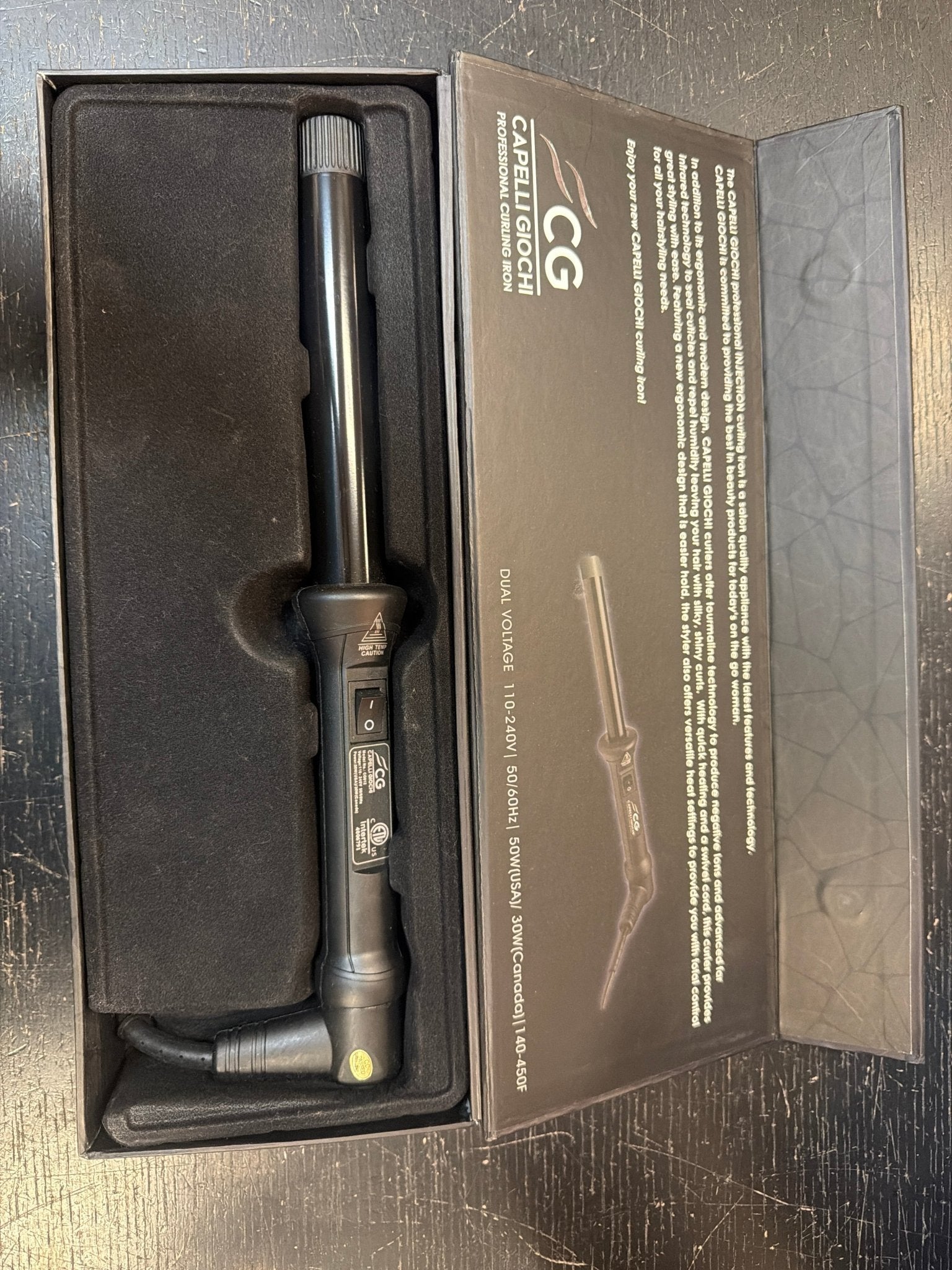 A professional 1-inch curling iron in a monochromatic black finish with a sleek minimalist design.