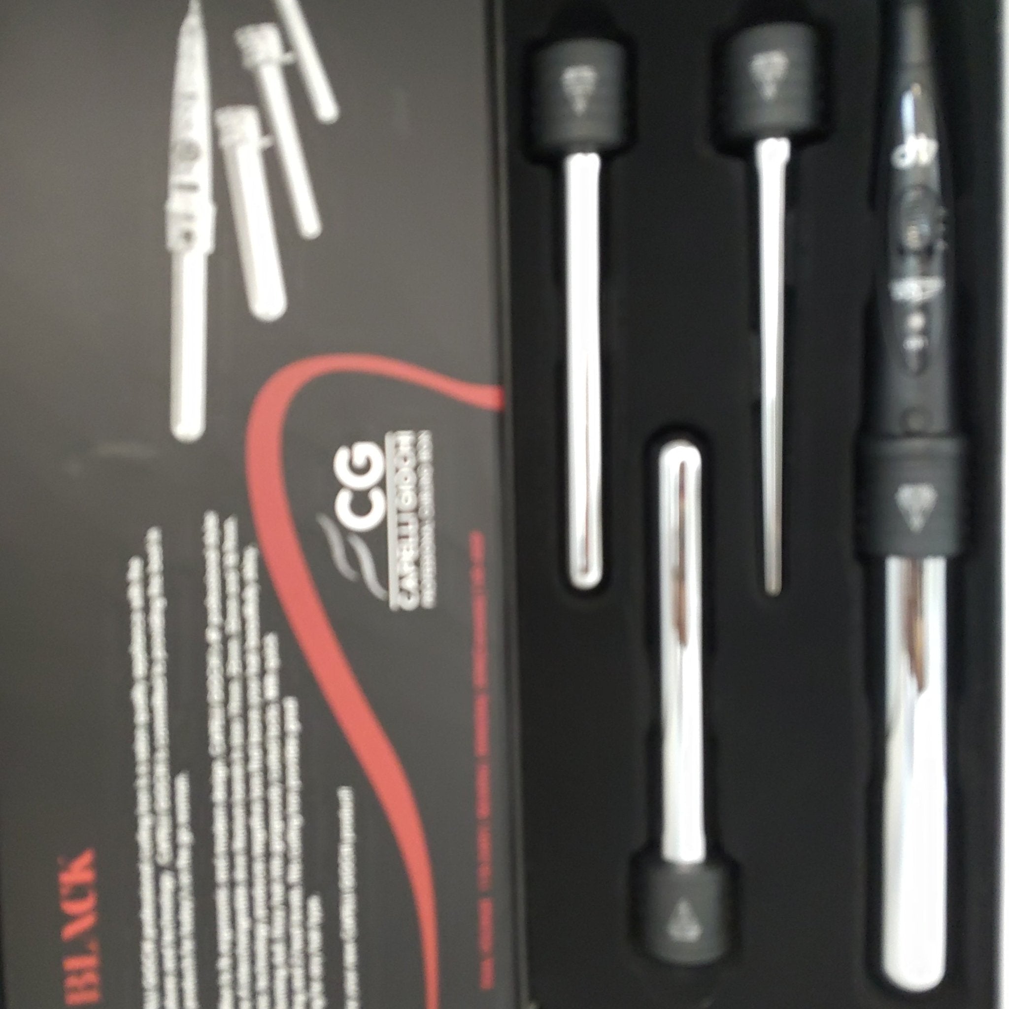 Professional 4P curling iron with sleek black housing and polished silver metallic barrels.