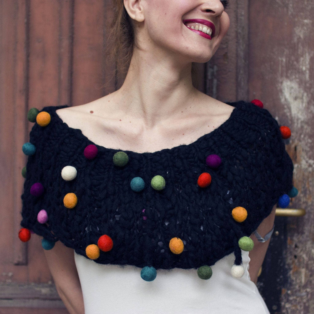 CaPowl knit cowl and poncho made with thick and thin yarn featuring handmade pom poms