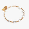 Two-tone expandable wire bangle featuring cat-head silhouettes and decorative accent beads.