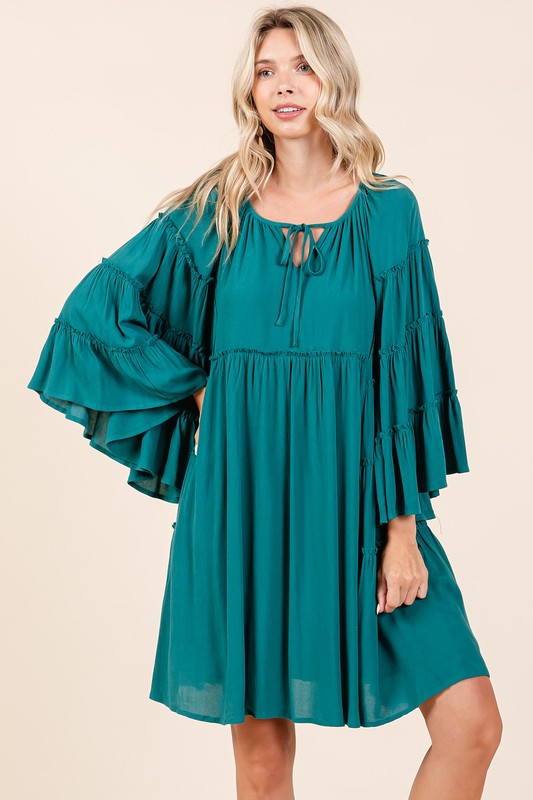 A feminine and sophisticated dress by Stevvex featuring frill details and bell sleeves.