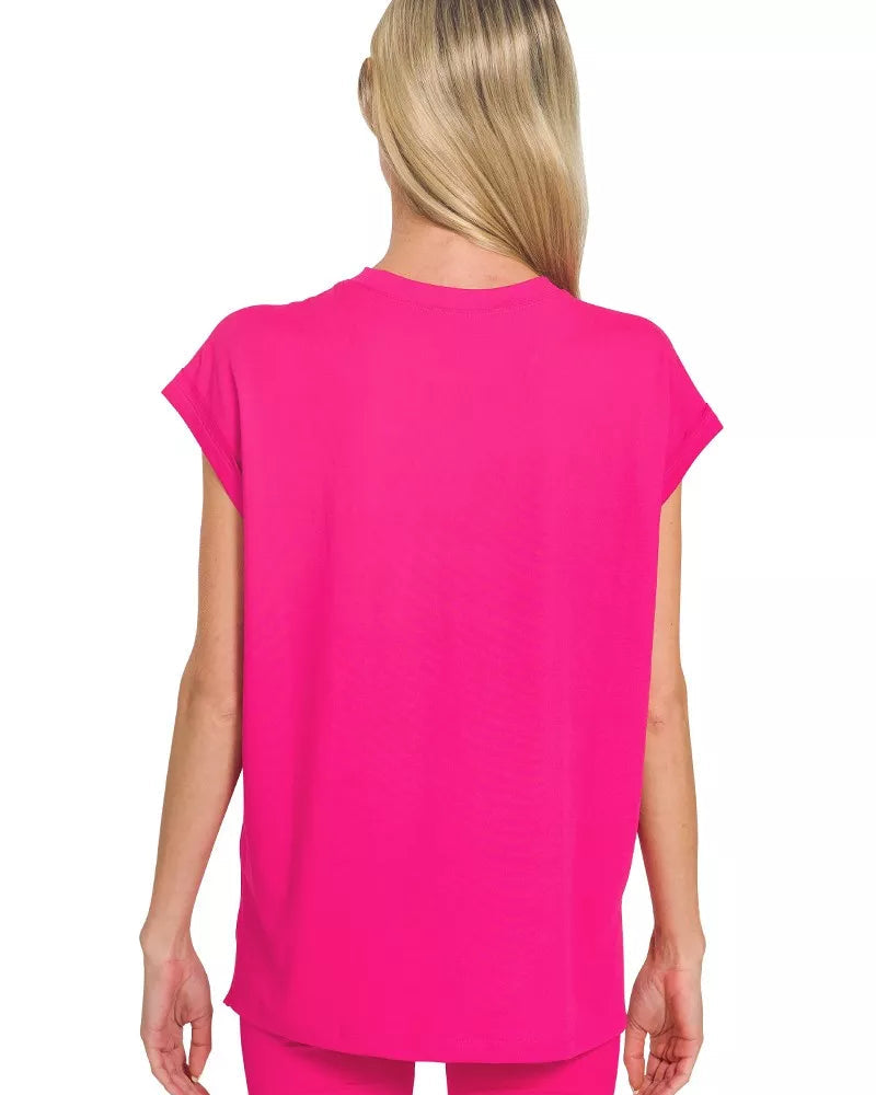 Woman wearing a bright pink top and shorts on a white background