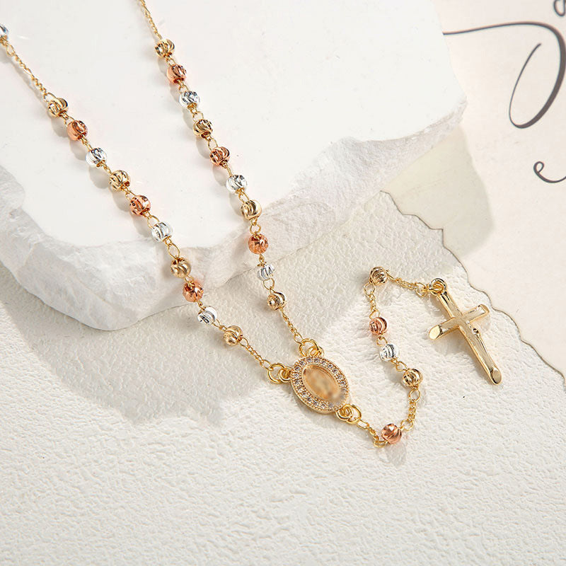 Retro-style gold-tone beaded cross necklace with a geometric design