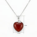 Close up of a 925 Sterling Silver heart necklace featuring a vibrant red gemstone pendant with clear crystals.